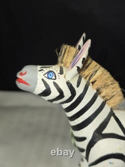 A hand carved and painted Mexican folk art mystical zebra alebrije