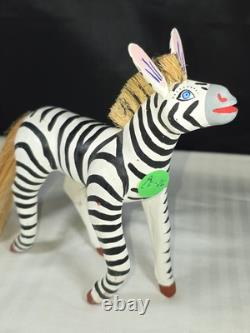 A hand carved and painted Mexican folk art mystical zebra alebrije