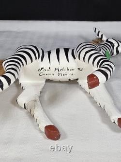 A hand carved and painted Mexican folk art mystical zebra alebrije