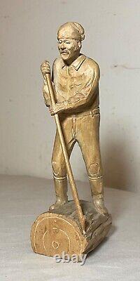 Antique hand carved wood Folk Art lumberjack man cutting wood sculpture statue