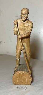 Antique hand carved wood Folk Art lumberjack man cutting wood sculpture statue