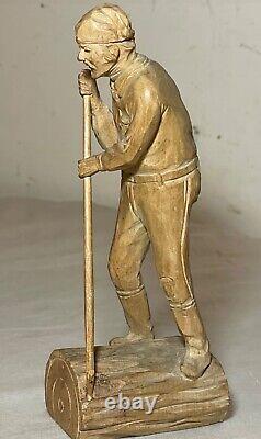 Antique hand carved wood Folk Art lumberjack man cutting wood sculpture statue