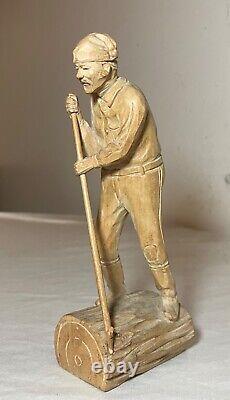Antique hand carved wood Folk Art lumberjack man cutting wood sculpture statue