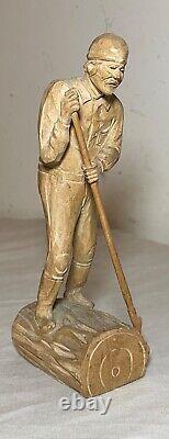 Antique hand carved wood Folk Art lumberjack man cutting wood sculpture statue
