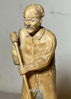 Antique hand carved wood Folk Art lumberjack man cutting wood sculpture statue