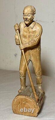 Antique hand carved wood Folk Art lumberjack man cutting wood sculpture statue