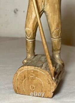 Antique hand carved wood Folk Art lumberjack man cutting wood sculpture statue