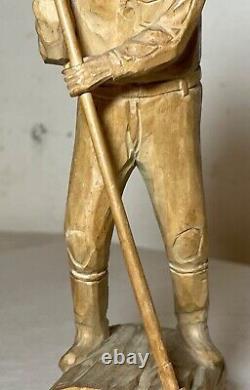 Antique hand carved wood Folk Art lumberjack man cutting wood sculpture statue