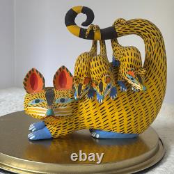 Oaxacan wood-carved alebrije depicting a possum with three babies