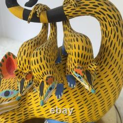 Oaxacan wood-carved alebrije depicting a possum with three babies