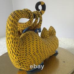 Oaxacan wood-carved alebrije depicting a possum with three babies