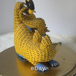 Oaxacan wood-carved alebrije depicting a possum with three babies