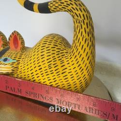 Oaxacan wood-carved alebrije depicting a possum with three babies