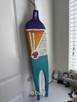 Painted wooden sculpture, known as a StoryPeople piece by the artist