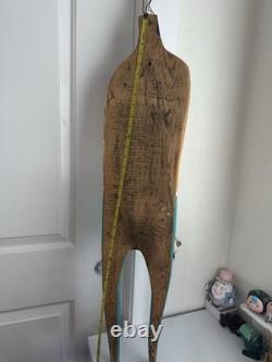 Painted wooden sculpture, known as a StoryPeople piece by the artist