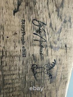 Painted wooden sculpture, known as a StoryPeople piece by the artist