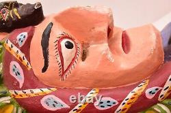 Art populaire mexicain antique : Masque de danse en bois sculpté représentant un tournesol et un homme serpent