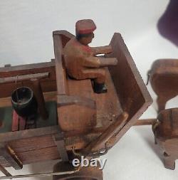 Art populaire primitive : Bœufs en bois sculptés à la main et chariot ancien mobile