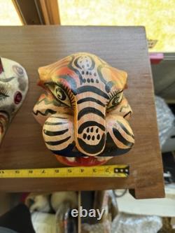 Masques de jaguar et de loup sculptés en art populaire mexicain