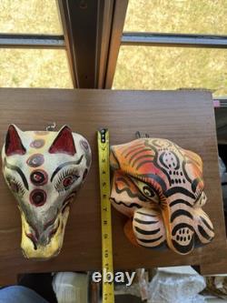Masques de jaguar et de loup sculptés en art populaire mexicain