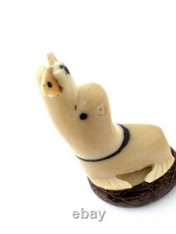 Sculpture en os vintage d'eskimo inuit représentant un phoque avec un poisson - Art populaire tribal alaskien
