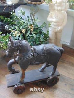 Sculpture unique en bois sculpté à la main d'un cheval vintage sur roues, art populaire
